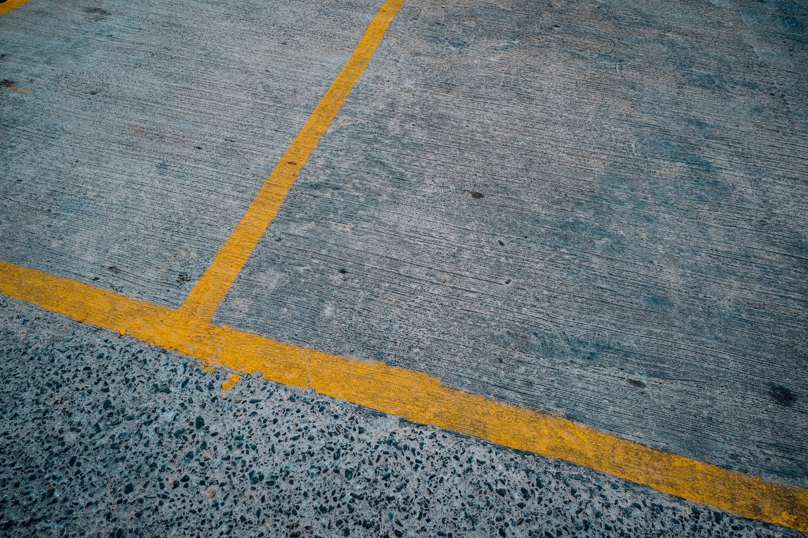 Yellow aisle striping on concrete warehouse floor